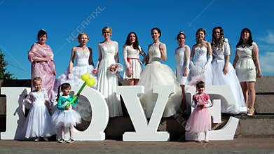 Many girls in wedding dresses, Many girls in wedding dresses, show class, a gesture of approval at arm's length
