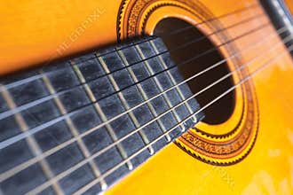 Strings, rose and soundboard of a guitar.