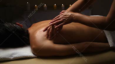 Man relaxing with massage at beauty spa.