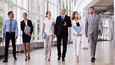 Business people walking along office building 6