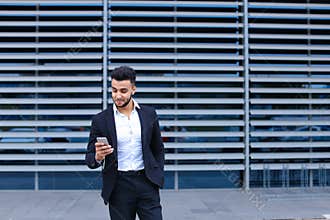 Young arabic man uses mobile smart phone business center