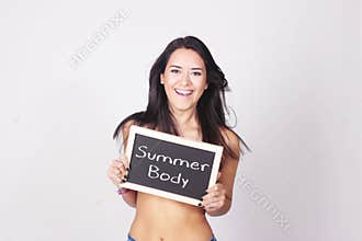 Young woman holding chalkboard saying Summer Body