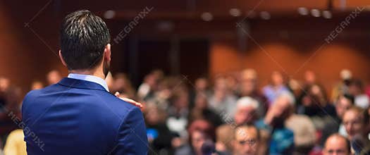 Public speaker giving talk at Business Event.