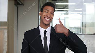 Thumbs Up by Black Businessman in Office