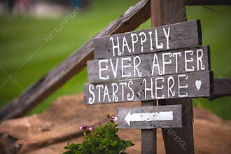Happily Ever After Starts Here sign at wedding venue