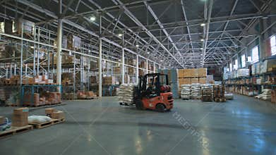 A huge grocery store. On the smooth floor goes truck with goods.
