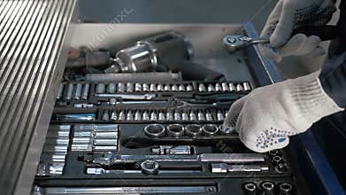 Mechanic open Blue Metal Box with Different Tools for Car Repair at Modern Service station
