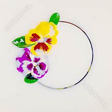 Viola tricolor in milk bath on circle background. Spring and summer, body care, purity, tenderness concept. Flat lay, top view