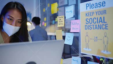 Happy Asia businesswoman wearing medical face mask for social distancing in new normal situation for virus prevention while using