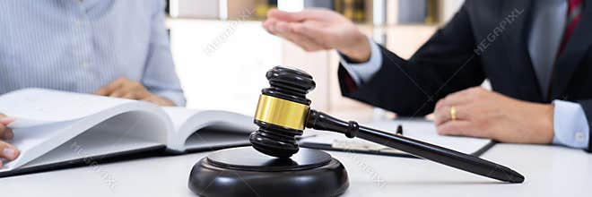 Client with his partner lawyers or attorneys discussing discussing a document or contract agreement working at table in office,
