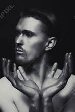 Portrait of young man with silvery makeu