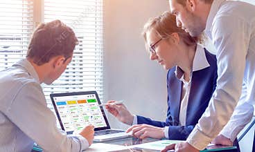 Daily team meeting around agile product development board with scrum or kanban framework, lean methodology, iterative or