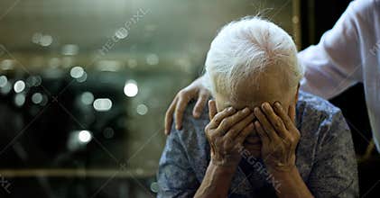 The daughter is comforting an elderly woman who is a mother sadness with Alzheimer`s disease and amnesia, Memory loss due to