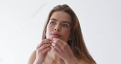 Girl looking at mirror and removing pimple, worry about acne