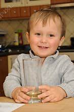 Boy holding glass with drink
