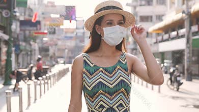 Young brunette woman traveling in Bangkok, Thailand in popular Khao San Road during pandemic Coronavirus. 20s Hispanic