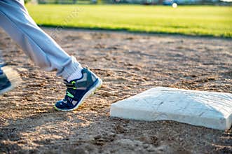 Youth baseball with a runner taking off for the next base