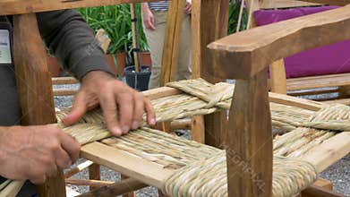 Craftsman builds a wooden chair.