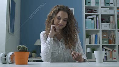 Young woman social networking with her tablet