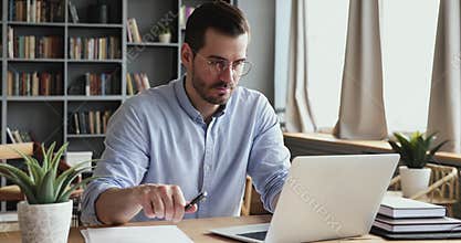 Concentrated male professional analyzing market research information.