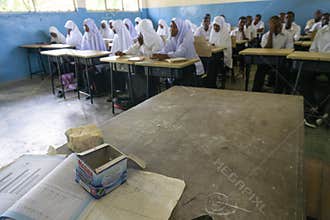 PEMBA ISLAND, ZANZIBAR, TANZANIA - JANUARY 2020: School girls and School Boys in the Ordinary class room With a Teachers