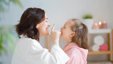 Mother and daughter caring for skin.