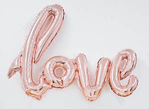 Inflatable word love near white wall. balloon letters