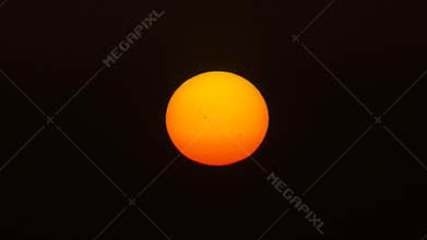 The sun showing dark sunspots