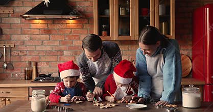 Family with kids wear aprons prepare Christmas cookies in kitchen
