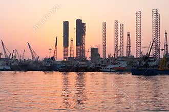 Oil rigs at sunset, Sharjah, Uae