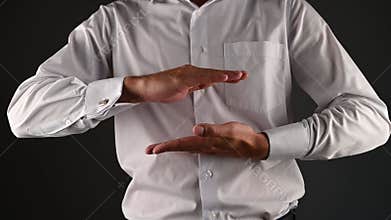 A man in a suit shows the size with his hands. High quality video