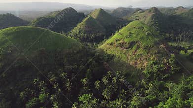 Timelapse green grass hills aerial: building, path at mounts ranges. Filipino nobody nature scape