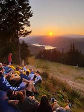 People relaxing watching sunset in the mountains