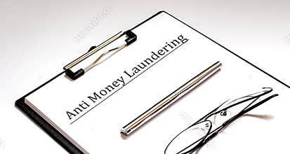 Paper with Anti-money laundering AML on a table