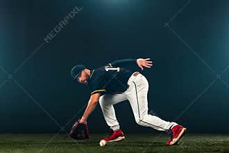 Baseball player on dark background. Ballplayer portrait.