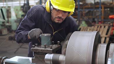 Smart factory worker using machine in factory workshop