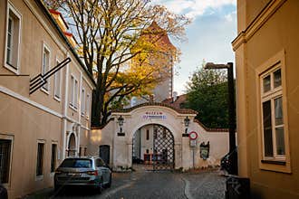 Autumn street and arched gate of the renaissance castle and regional museum in Mlada Boleslav, Central Bohemian Region, Czech