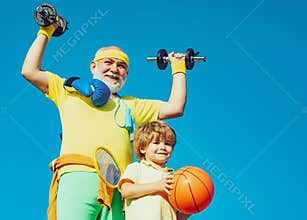 Family sport. Like sports. Fathers day. Healthy family lifestyle. Grandfather and child is doing sport outdoors. Healthy