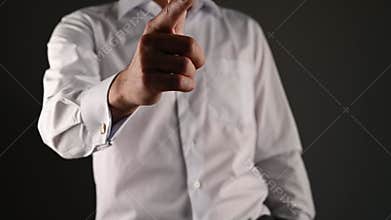 The man holds his index finger in front of him. A man in a suit points a finger