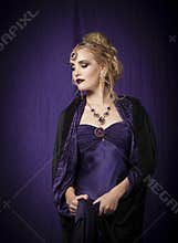 Theatrical portrait of blonde woman in purple Byzantine period dress