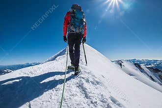 Last steps before Mont Blanc Monte Bianco summit 4,808 m of man with climbing axe dressed mountaineering clothes, boots with
