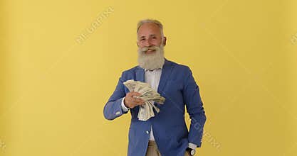 Rich businessman waving fan of cash dollar bills