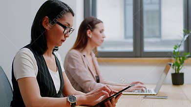 Two Focused Businesswomen Write Research