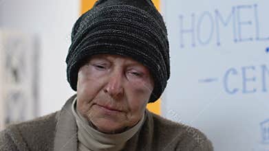 Abandoned homeless female looking to camera in despair, social support center