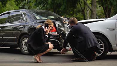 Female driver calling insurance company after road accident, rear-end collision