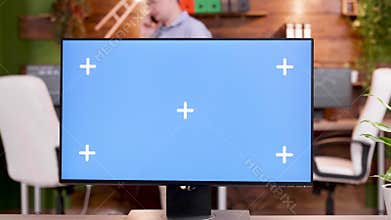 POV of man at his workplace typing on computer with green screen