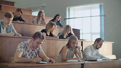 Hands of the Lecturer while he Gives Lecture to a Classroom Full Of Students. Young People Listening to a Lecture in the
