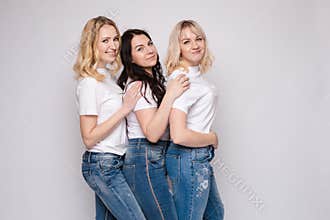 Side view of beautiful young women standing one by one.