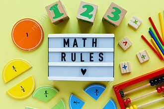 Creative Ð¡olorful blocks, light box, fractions on yellow background. Interesting funny math for kids. Education, back to school