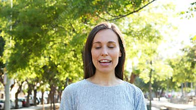 Adult woman talking to camera in a park